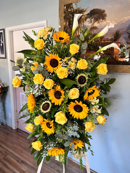 yellow roses, sunflowers, and leaves on stand